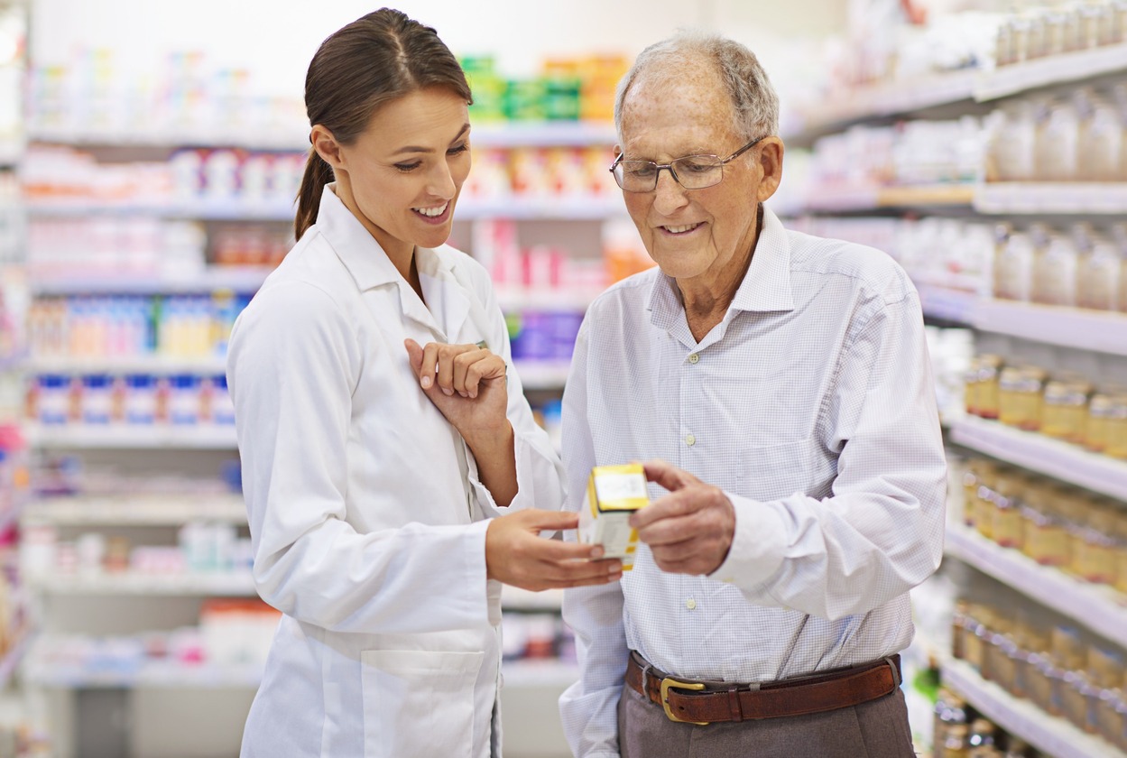 Farmacéutica asesorando a un anciano